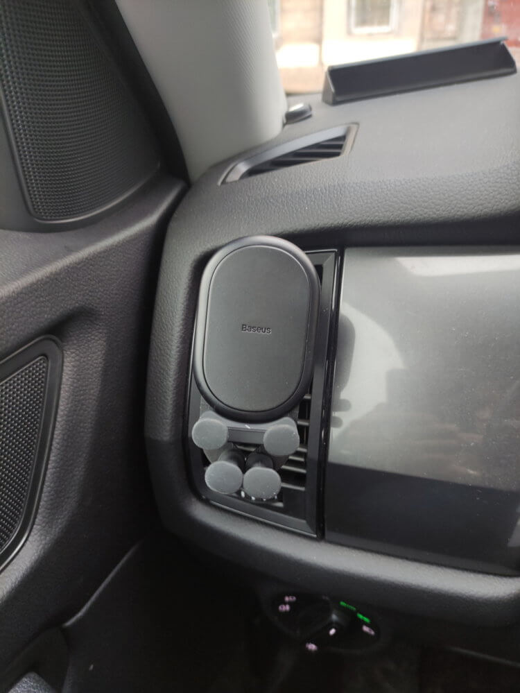 Car holder for smartphone.  The holder fits very organically into the interior of the car.  Photo.