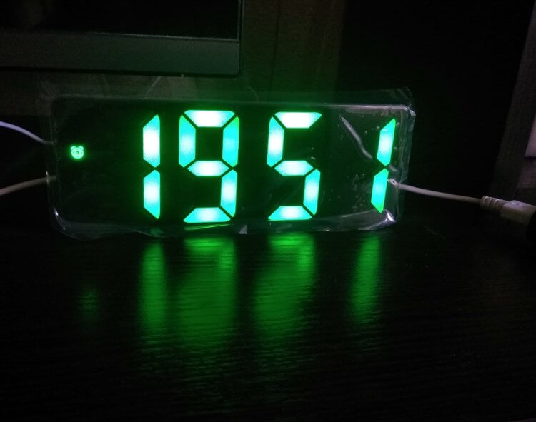 Electronic table clock with an alarm clock.  The numbers are bright and easy to read in the dark.  Photo.