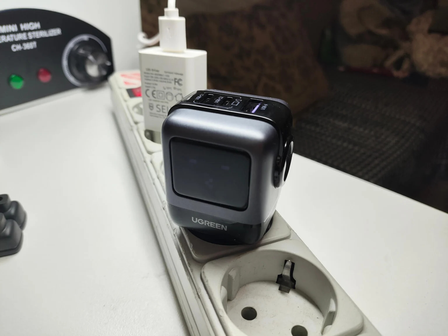 Быстрая зарядка для iPhone, iPad и Mac в стильном дизайне. У зарядки есть свой небольшой экранчик. Фото.