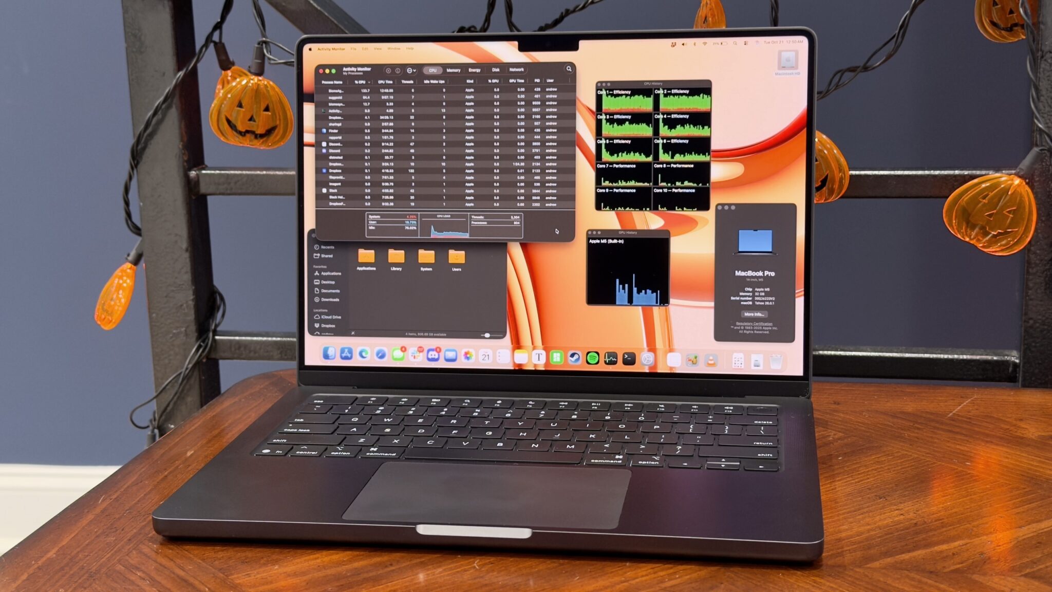 MacBook Pro на M5 с открытым «Мониторингом системы»: графики загрузки ядер процессора и видеочипа